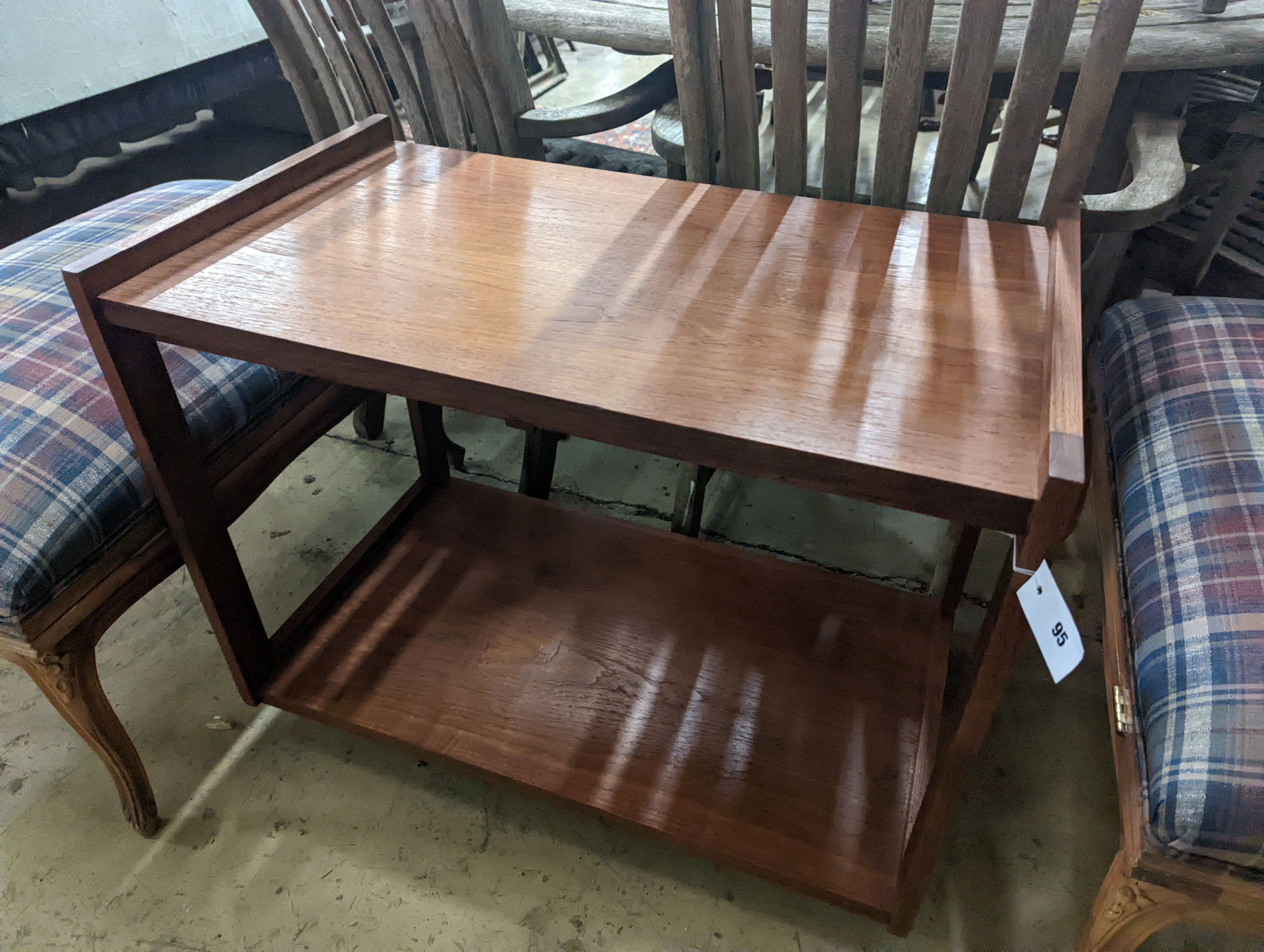 A 1960's rectangular teak two tier table fitted slides, width 80cm, depth 48cm, height 65cm